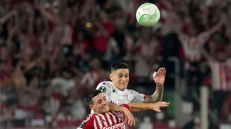 Fiorentina's Lucas Martinez Quarta jumps for the ball with Olympiacos'...