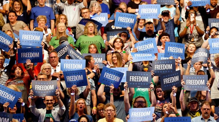 Supporters listen as Minnesota Gov. Tim Walz speaks during a...