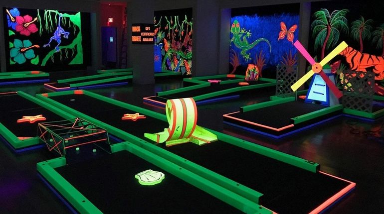 A new glow-in-the-dark indoor mini-golf venue opened this month at...