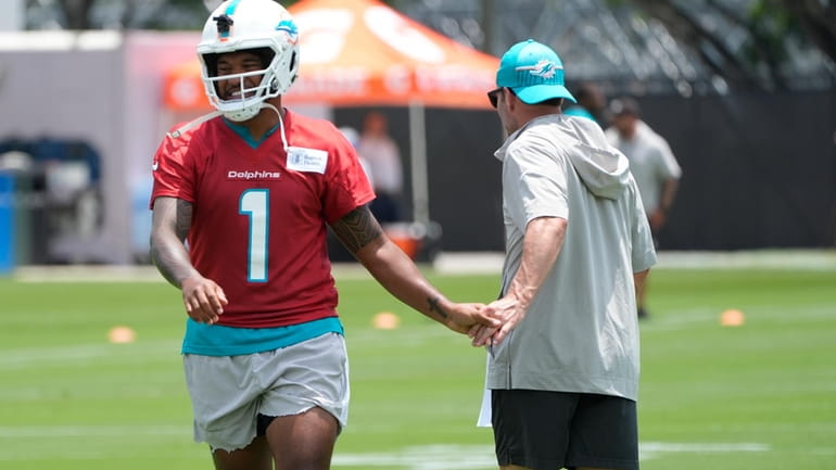 Miami Dolphins quarterback Tua Tagovailoa (1) greets a member of...