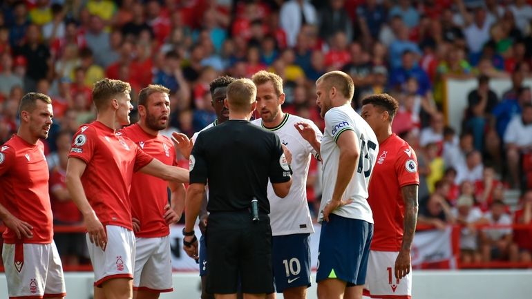 Players argue with the referee during the English Premier League...