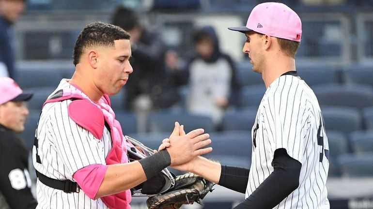 Yankees catcher Gary Sanchez and relief pitcher Chasen Shreve celebrate...