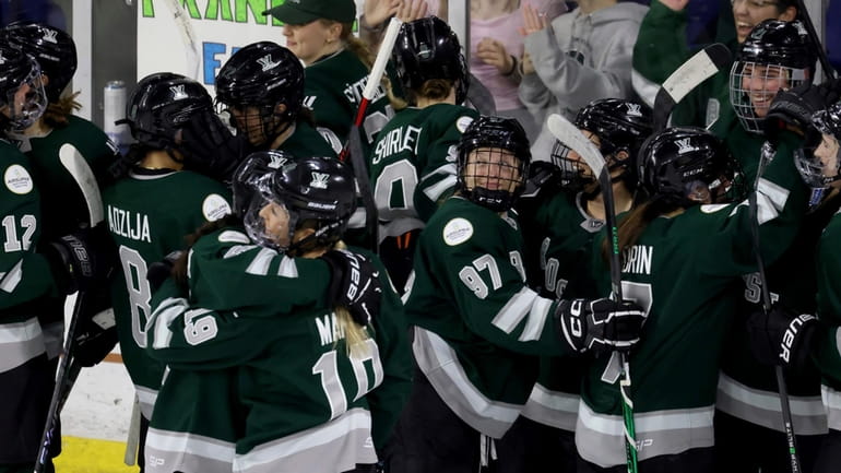 Boston players, including defender Jess Healey (97), celebrate an overtime...