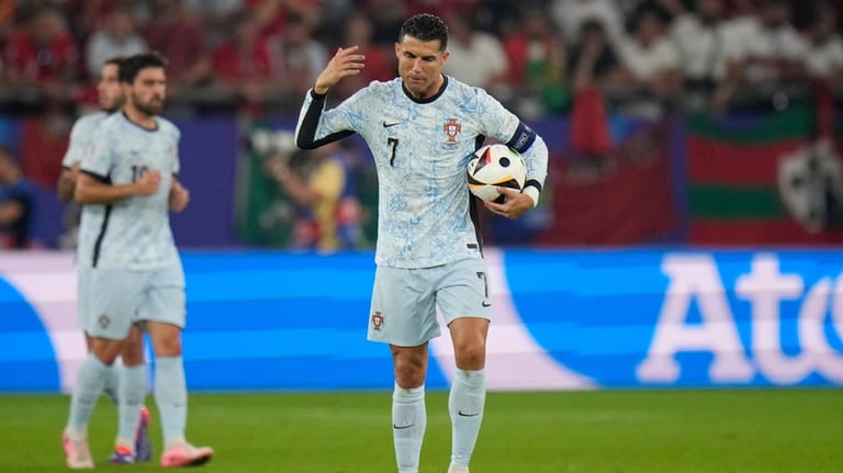 Portugal's Cristiano Ronaldo gestures after Georgia's Georges Mikautadze scored his...
