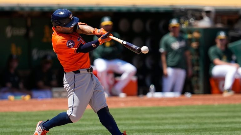 Houston Astros' Jose Altuve hits an RBI double against the...