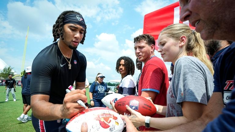 Houston Texans quarterback C.J. Stroud signs autographs during an NFL...