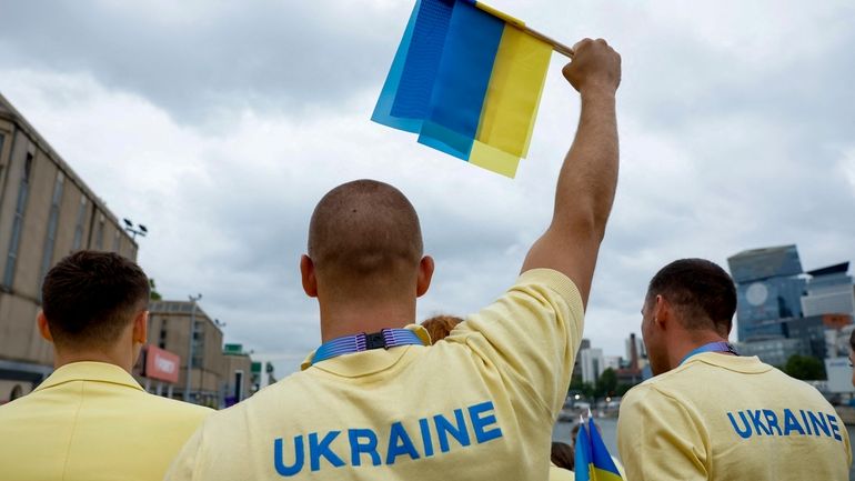 Ukraine's athletes stand on a boat ahead of the opening...