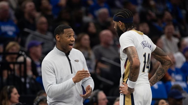 New Orleans Pelicans head coach Willie Green, left, talks with...