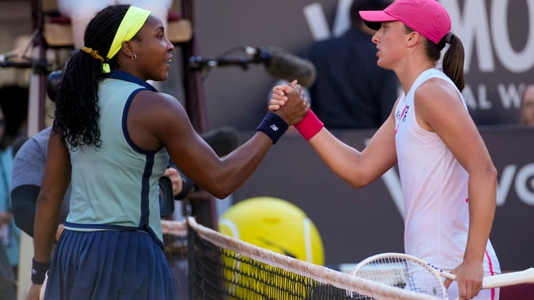 Coco Gauff of the United States, left, shakes hands with...