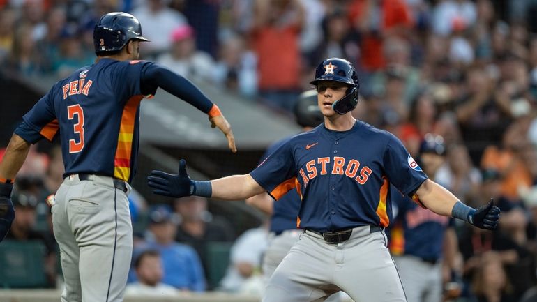 Houston Astros' Jake Meyers, right, celebrates with Jeremy Pena after...