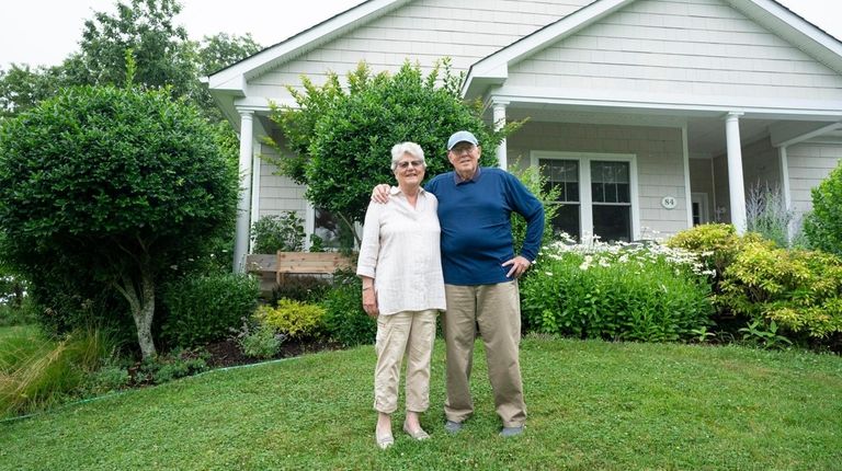 Sara and James Garretson in front of their cottage at Peconic Landing...