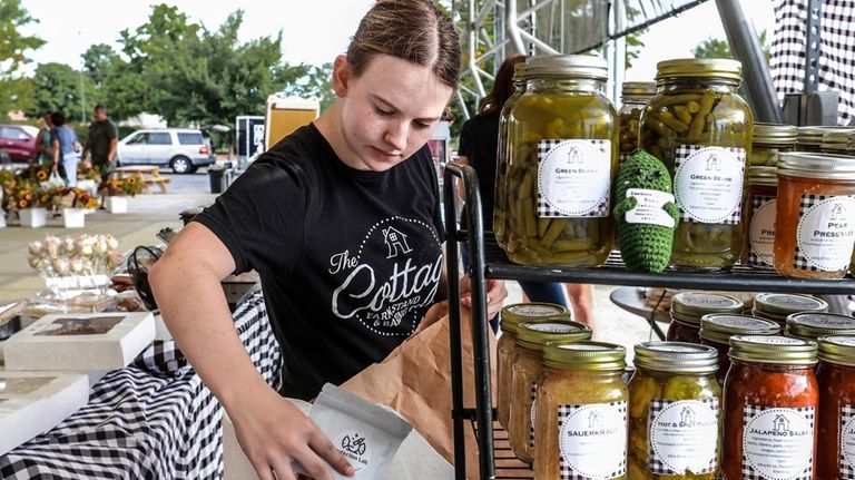 Lexia Smith stocks product while working in The Cottage Farm...