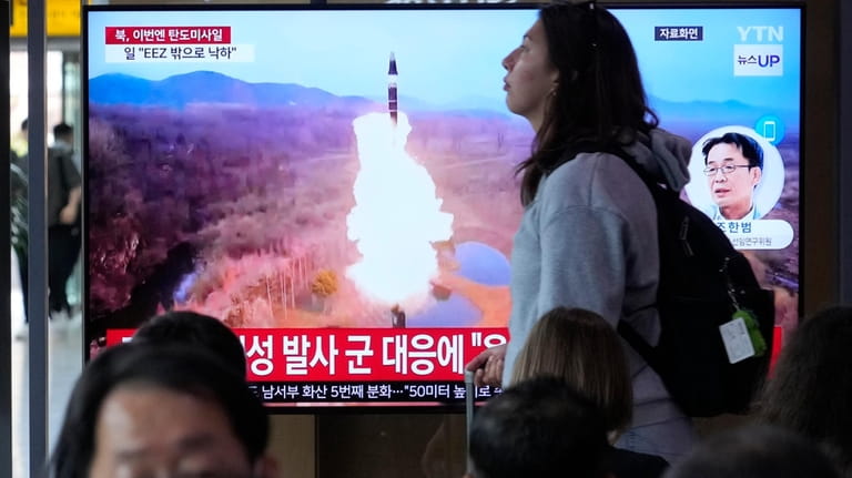 A news program broadcasts a file image of a missile...
