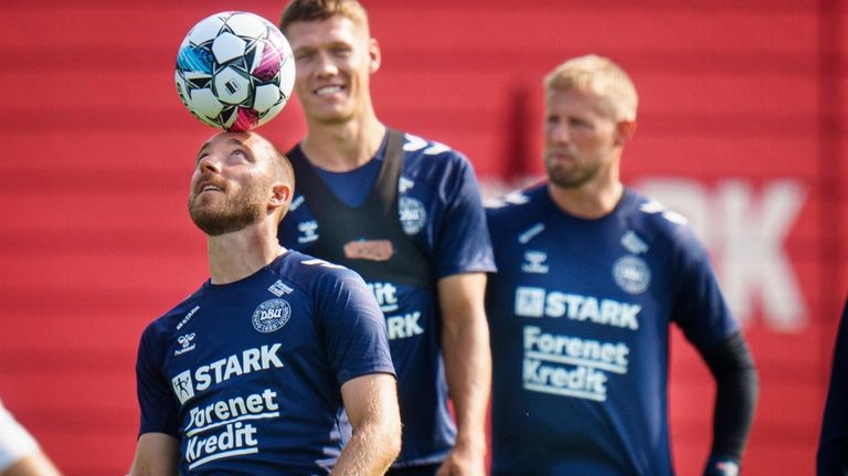 Denmark's Christian Eriksen, Jannik Vestergaard and Kasper Schmeichel attend a...