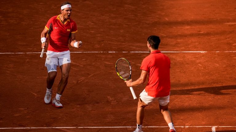 Carlos Alcaraz, right, and Rafael Nadal of Spain celebrate a...