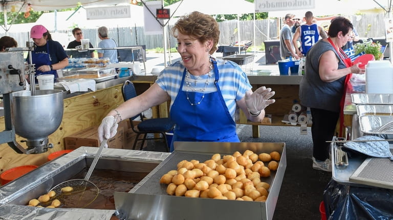 Voula Boutsikos volunteers at the Greek Festival in front of...