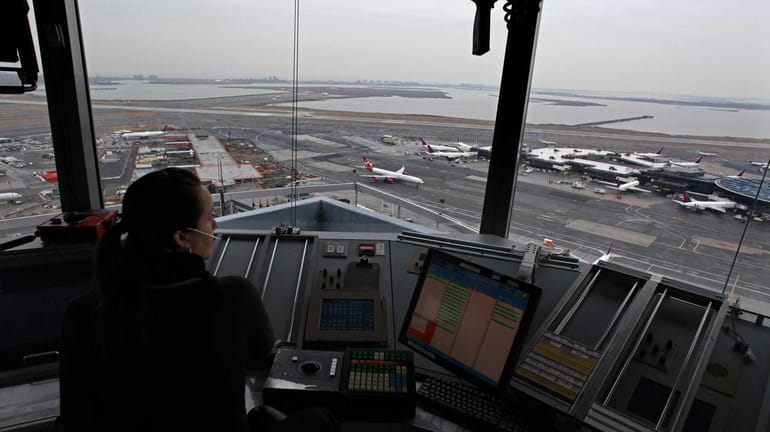 An air traffic controller looks out from the JFK control...