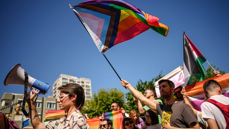 People shout slogans during the annual LGBTQ+ Pride March in...