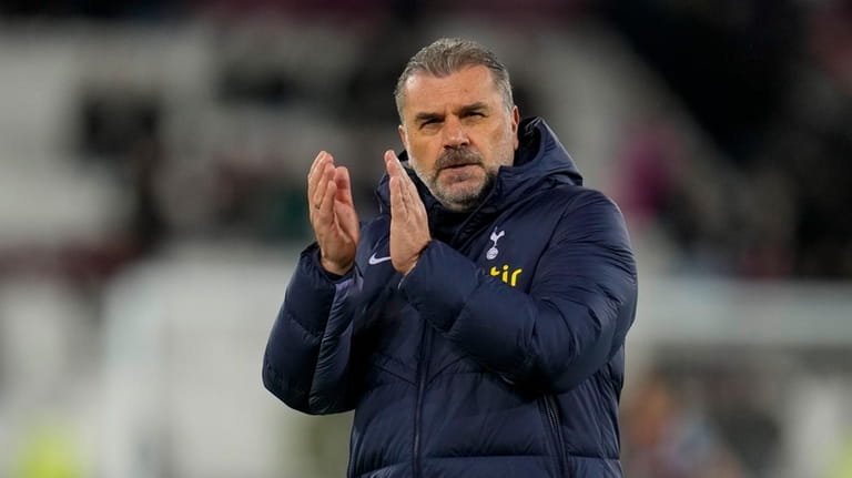 Tottenham's head coach Ange Postecoglou applauds at the end of...