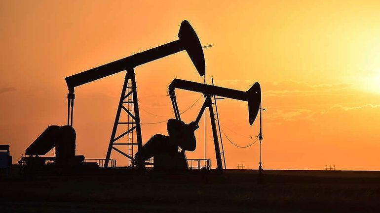 Pump jacks extract oil from beneath the ground in North...