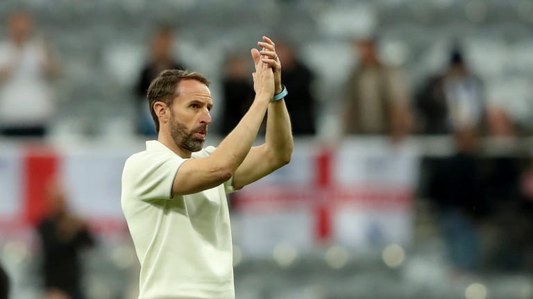 England coach Gareth Southgate applauds the fans at the end...