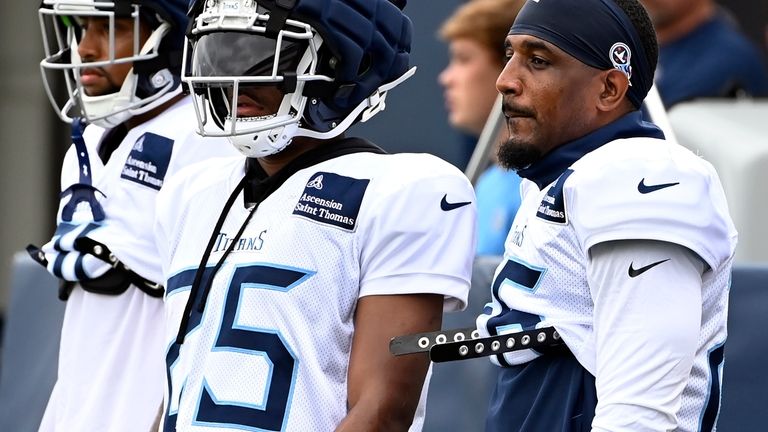 Tennessee Titans safety Quandre Diggs, right, watches from the sideline...