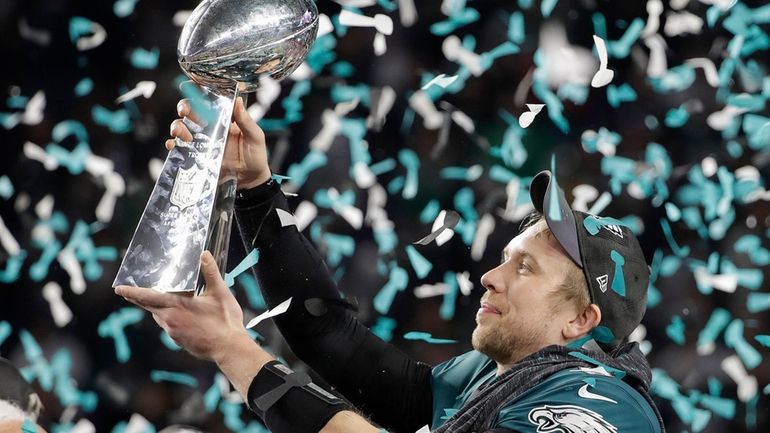 Philadelphia Eagles' Nick Foles holds up the Vince Lombardi Trophy...