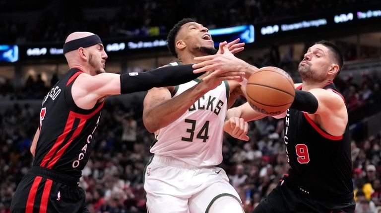 Milwaukee Bucks' Giannis Antetokounmpo (34) is fouled by Chicago Bulls'...