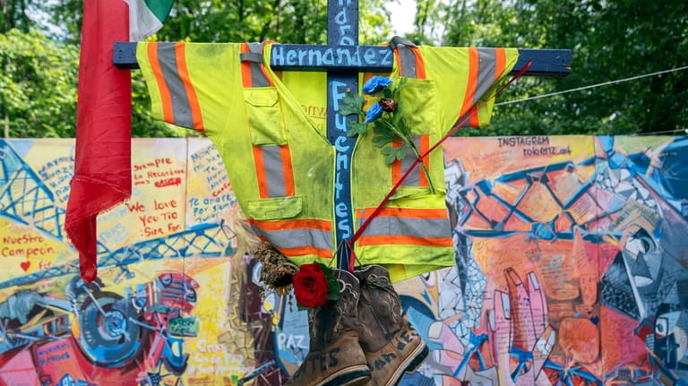 A cross memorializing construction worker Alejandro Hernandez Fuentes is displayed...