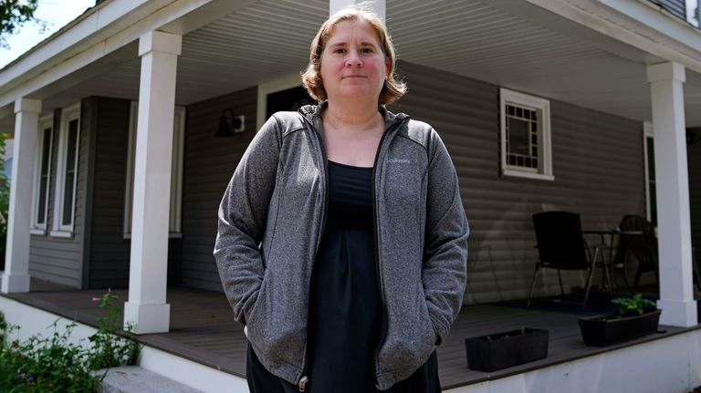 Rebecca Wood stands for a portrait outside her home, Friday,...