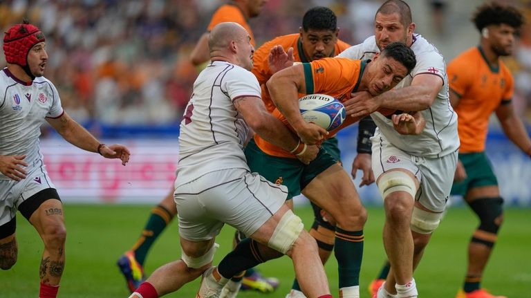 Australia's Lalakai Foketi, center, is talked by Georgian players during...