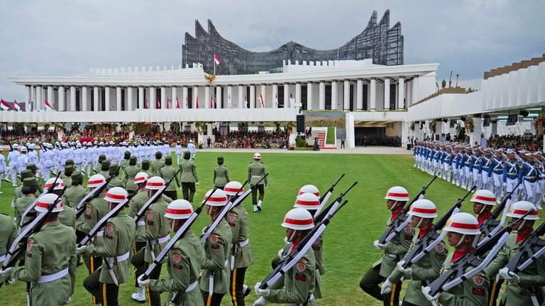 Soldiers march before the start of a ceremony marking Indonesia's...