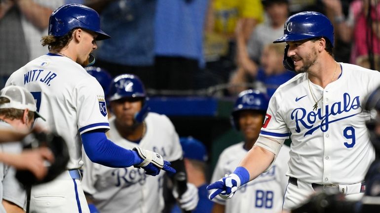 Kansas City Royals' Bobby Witt Jr., left, is congratulated by...