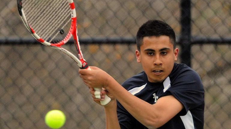 Half Hollow Hills East's Zain Ali returns a volley in...