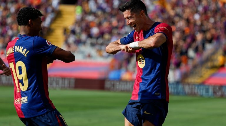 Barcelona's Robert Lewandowski, right, celebrates scoring his side's 2nd goal...