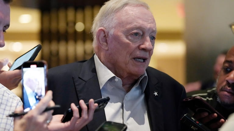 Dallas Cowboys owner Jerry Jones responds to reporters' questions after...