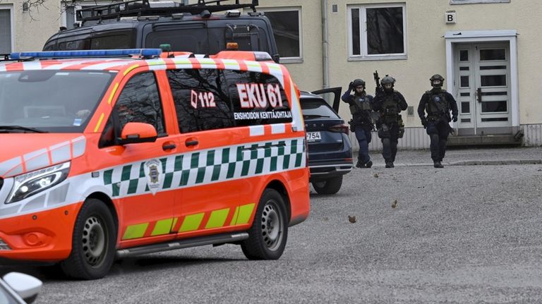 Police officers at the scene of Viertola comprehensive school, in...