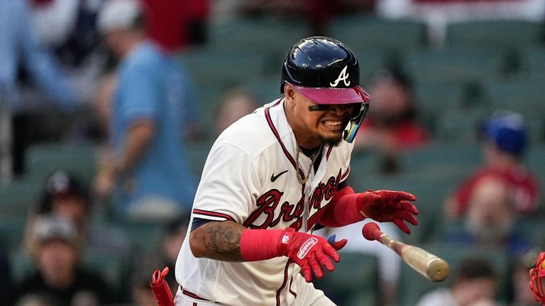 Atlanta Braves' Orlando Arcia reacts after being hit by a...