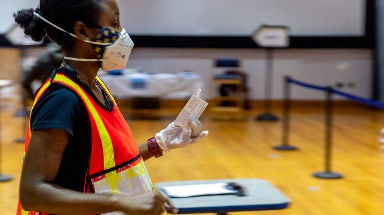 A runner with the Nassau County Department of Health carries...