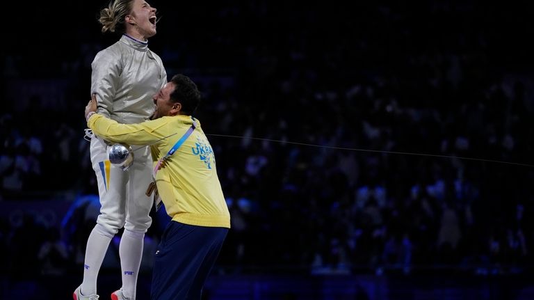 Ukraine's Olga Kharlan celebrates after winning the women's team sabre...