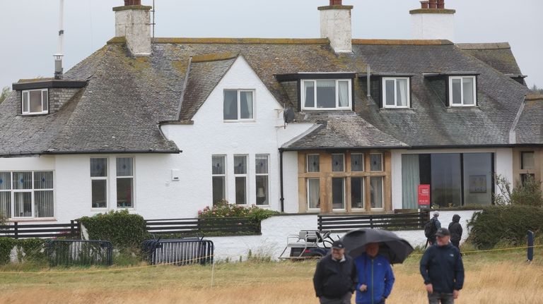 Spectators walk past "Blackrock house" that is listed for sale...