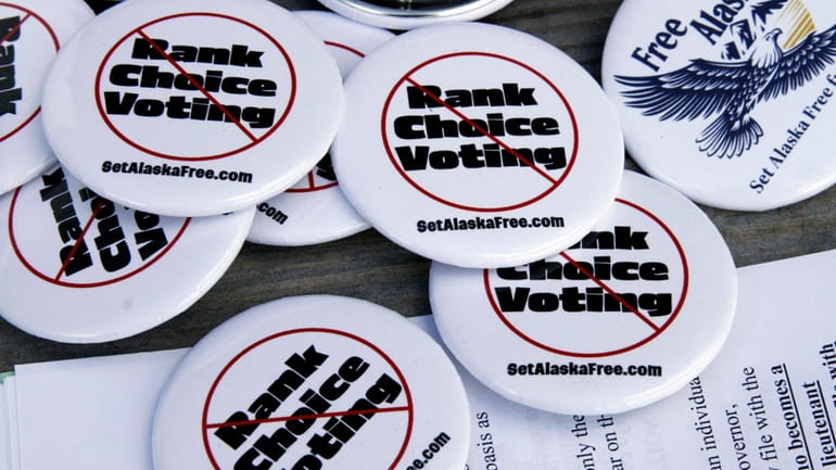 Campaign buttons urging Alaskans to repeal ranked choice voting in...