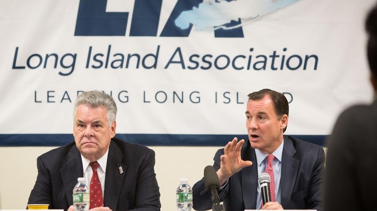 Congressman Tom Suozzi, right, speaks beside Congressman Peter King during...