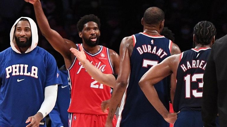 76ers center Joel Embiid and Nets forward Kevin Durant exchange...