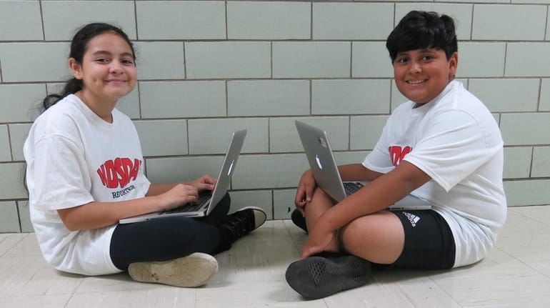 Kidsday reporters Alexa Larios and Angelo Maldonado enjoy their computer...