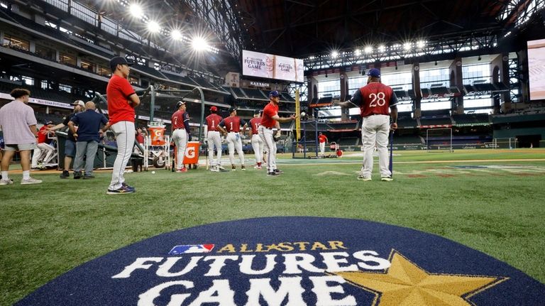 American League team members warm up during batting practice before...