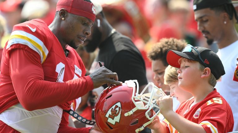 Kansas City Chiefs wide receiver Cornell Powell signs an autograph...