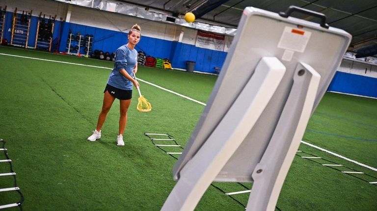 Erin Schaefer practices her lacrosse game on the Rebounder.