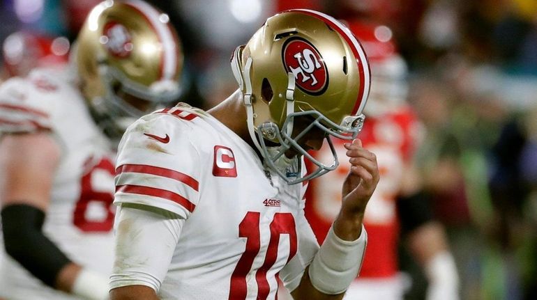 San Francisco 49ers quarterback Jimmy Garoppolo walks to the sideline...