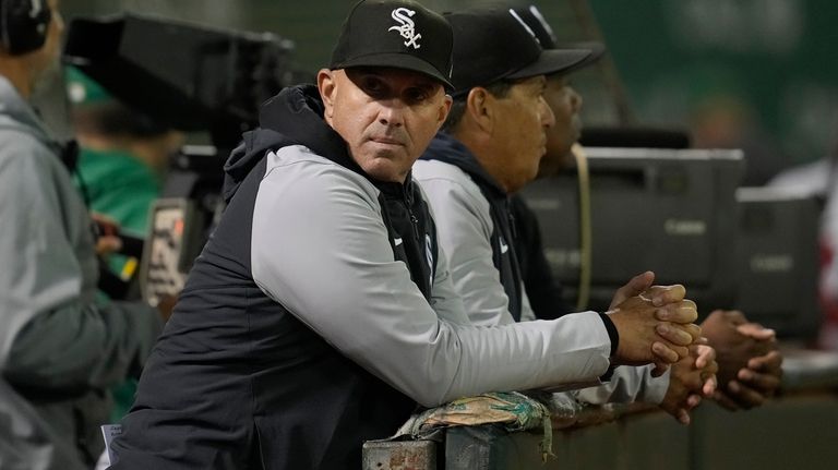 Chicago White Sox manager Pedro Grifol looks toward the dugout...